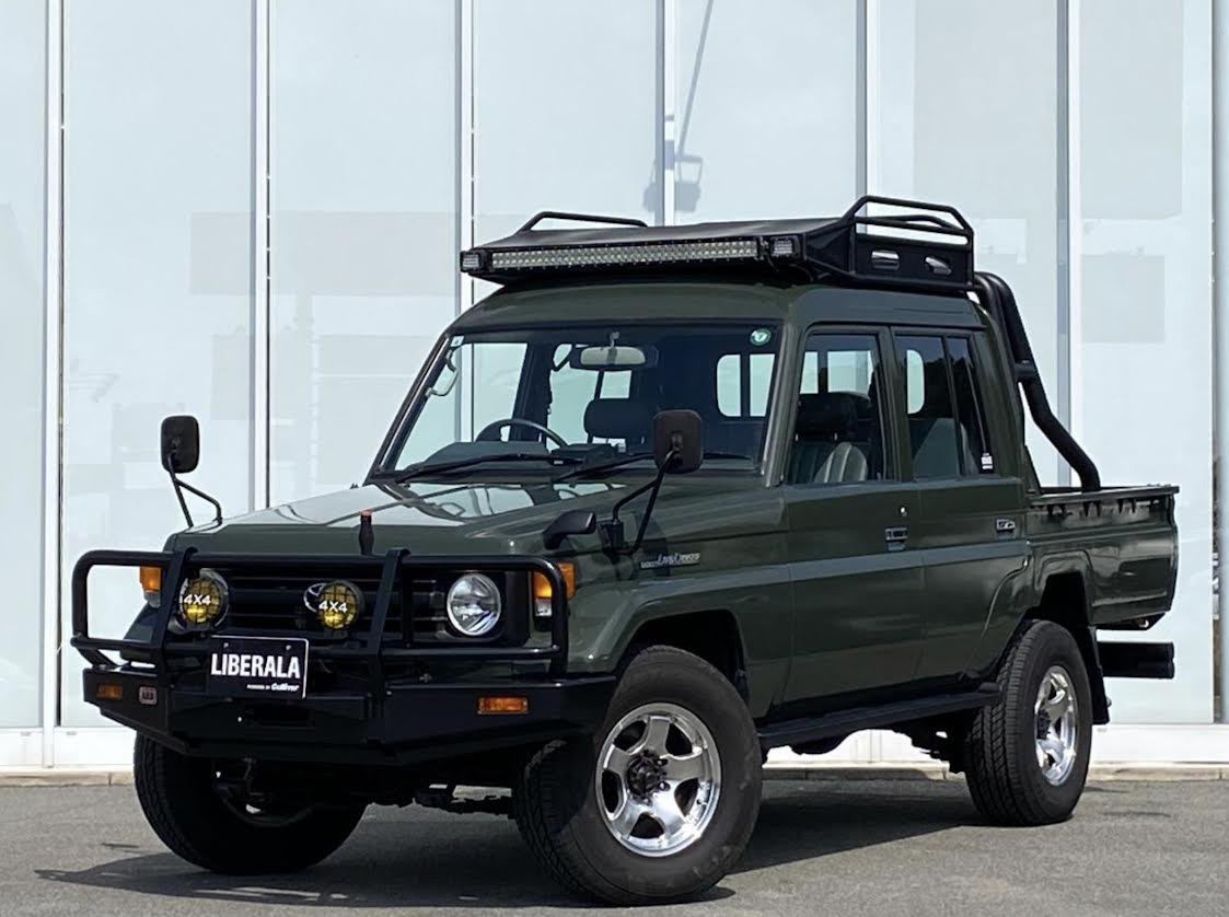 Dark green LC70 Ute at LIBERALA, front 3/4 view